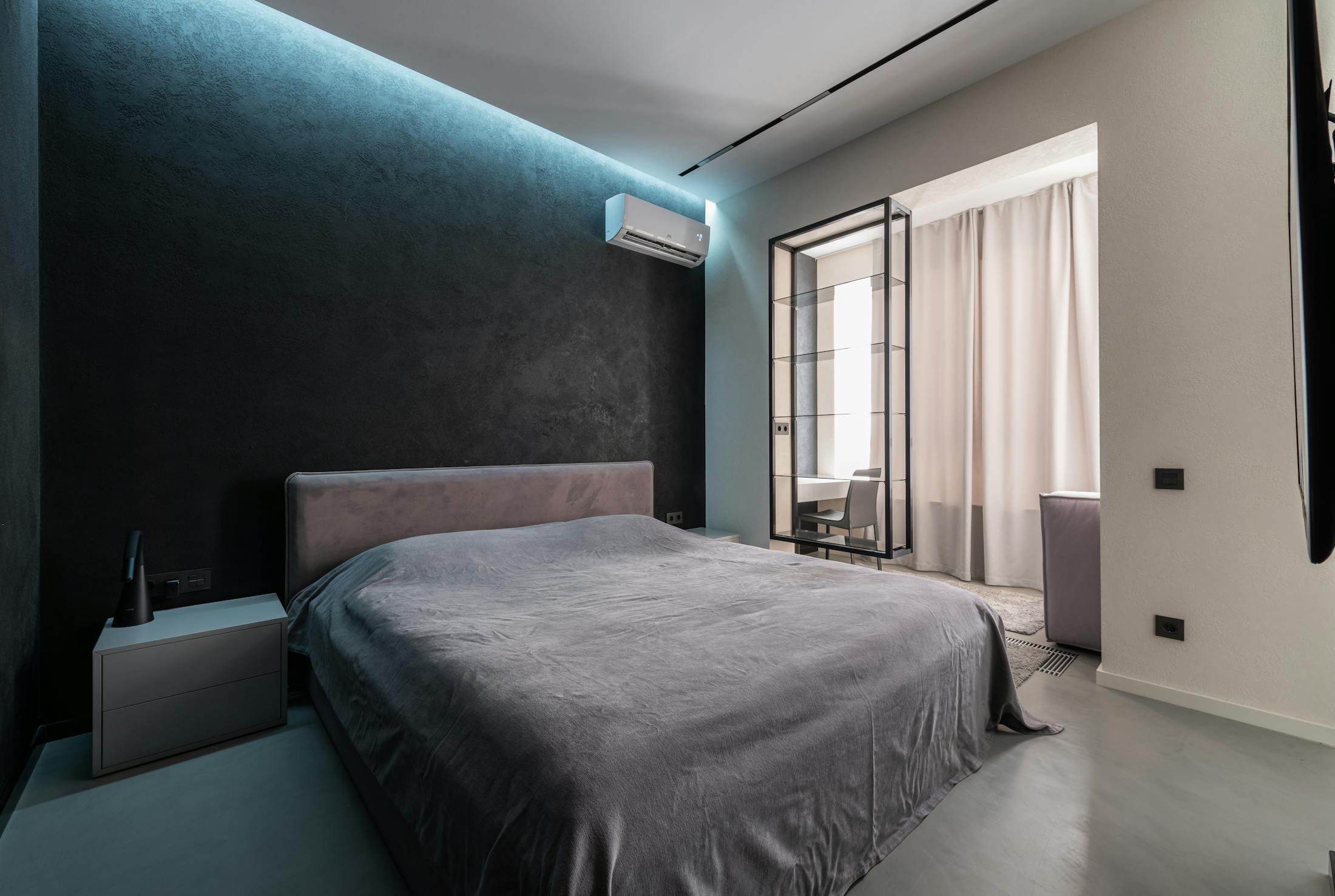 Premium bedroom with wall mounted air conditioning and feature lighting